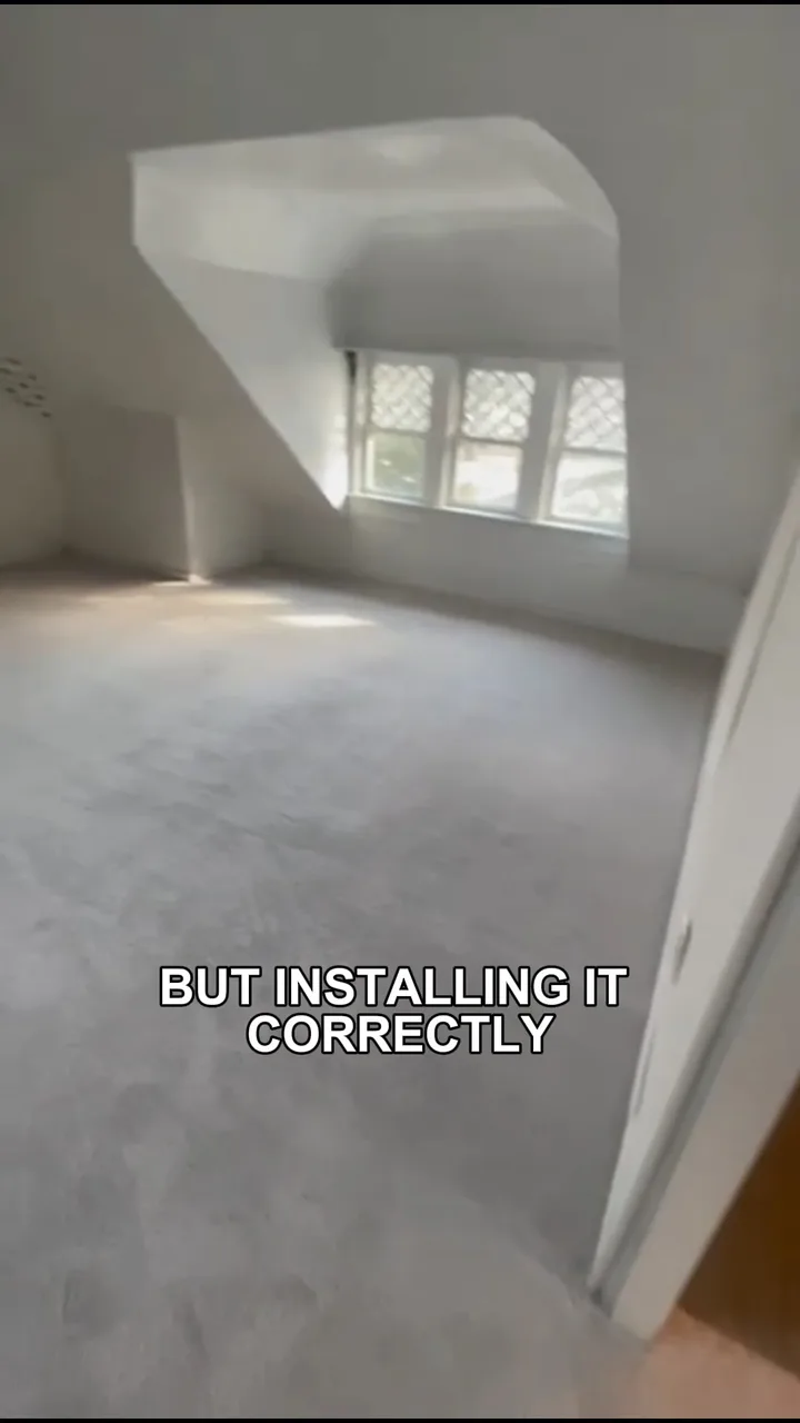 Light gray carpet installed in a bright room with an angled ceiling